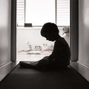 Kid looking down - black and white - sad